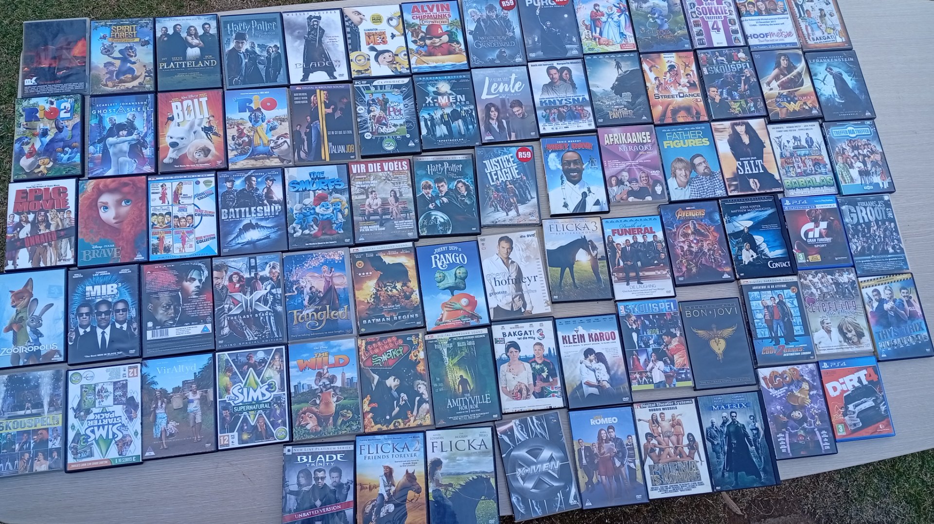 Bulk lot ~80 retail DVD & PS4 game cases — mixed movie titles, mostly original discs, untested