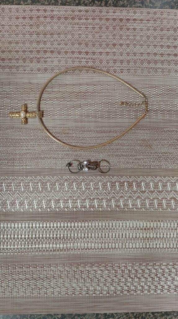 Mixed jewellery lot – gold-tone snake chain necklace with ornate cross pendant (central pearl‑style cabochon) + silver-tone charm/keyring