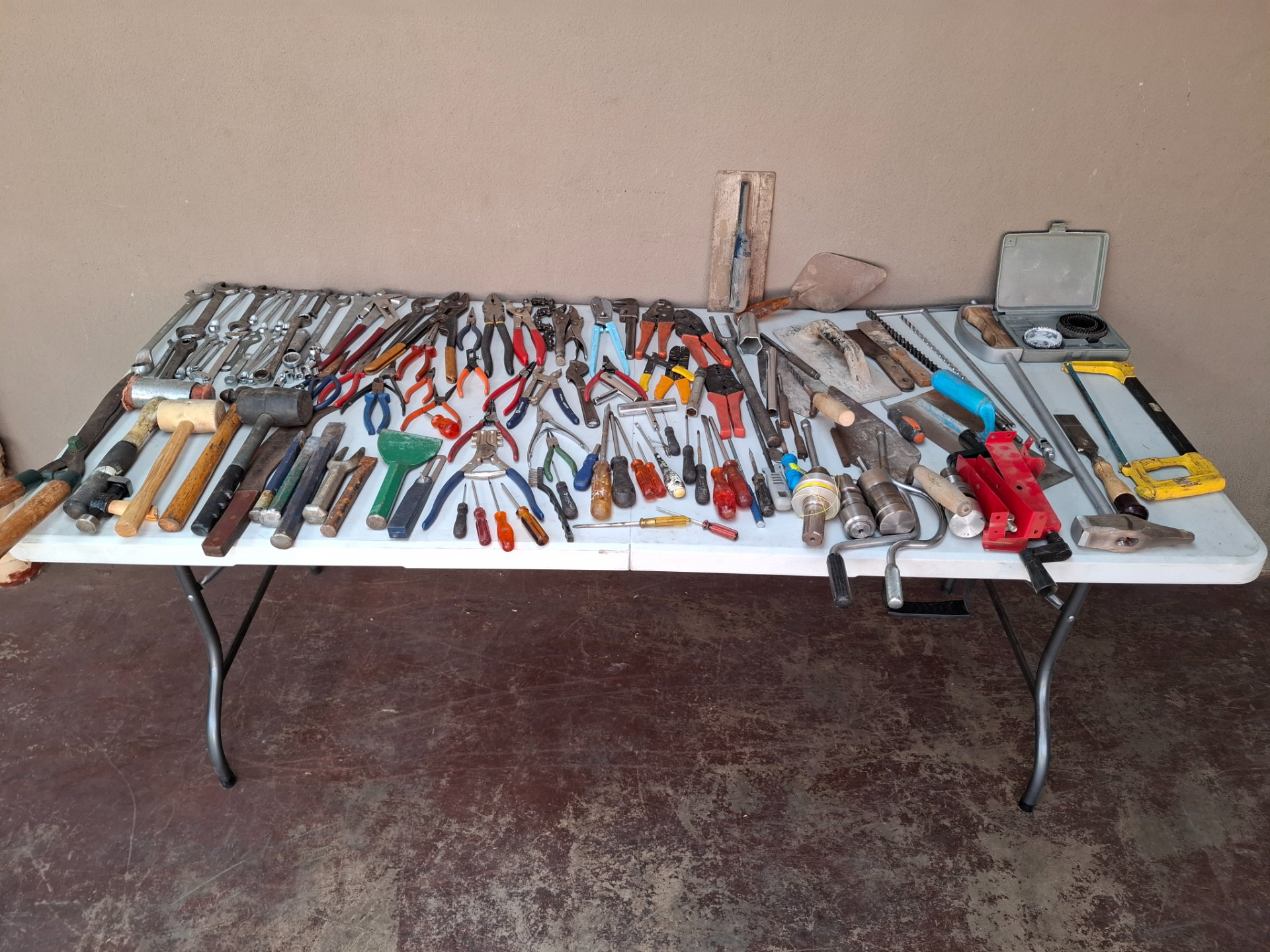 Large mixed lot of used hand tools — pliers, spanners, hammers, chisels, trowels, crimpers, hole‑saw set (sold as single lot)