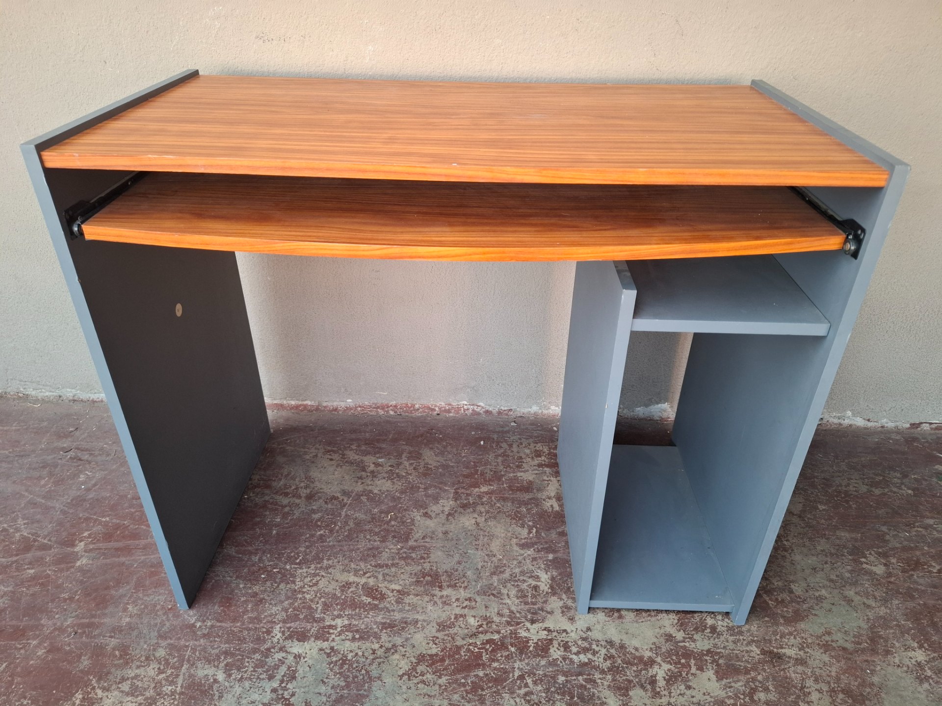 Compact computer desk with sliding keyboard shelf — grey sides, wood-effect top