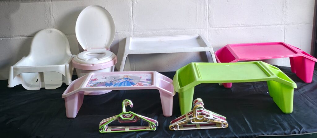 Mixed children’s plastic lot – booster/highchair insert, potty with inner bowl & lid, 4 kid trays + 2 stacks of small hangers (8 items)