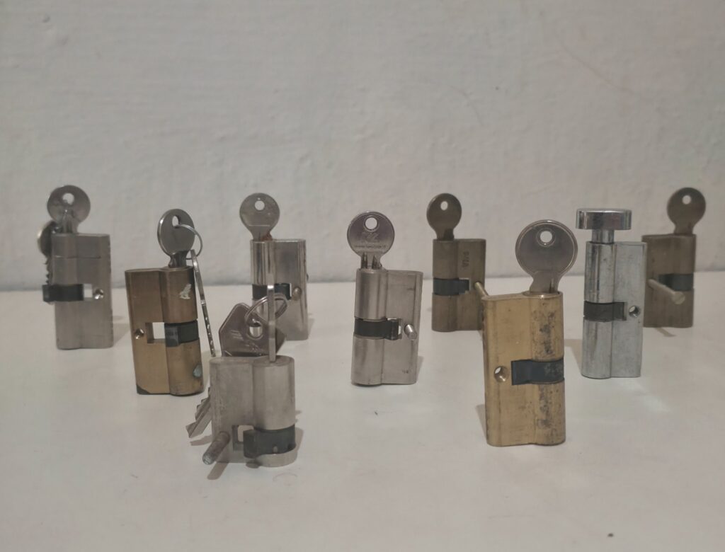 Lot of 9 Euro-profile lock cylinders with keys — used, mixed brass & chrome finishes