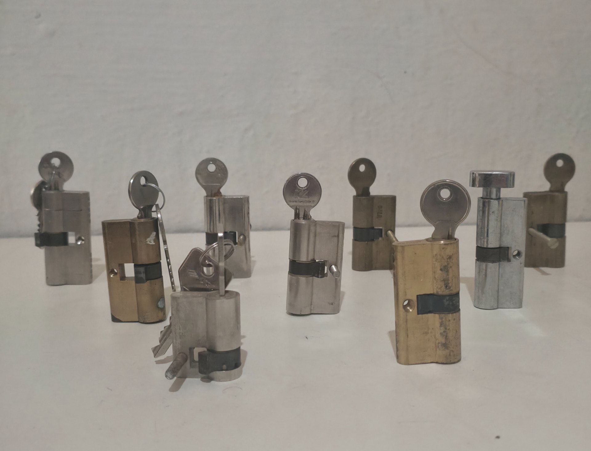 Lot of 9 Euro-profile lock cylinders with keys — used, mixed brass & chrome finishes