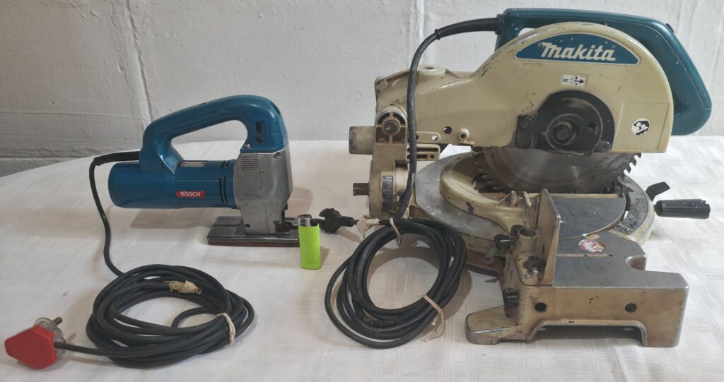 Makita mitre/compound saw (blade fitted) + Bosch jigsaw — used, power-on checked, needs attention