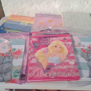 Bulk lot — approx 50 mixed-design paper gift bags (90% in packs) — kids, floral & striped styles
