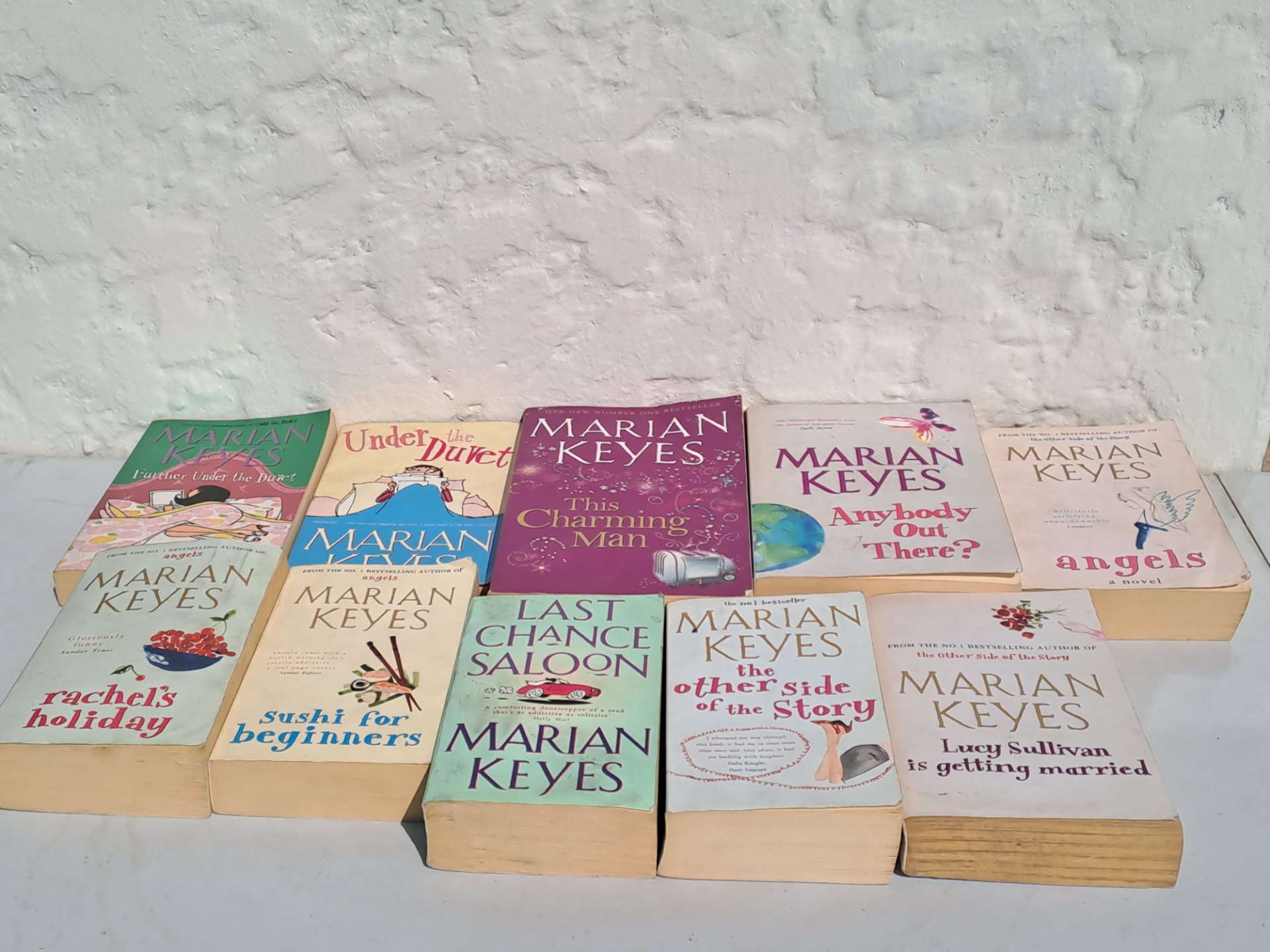 Lot of Marian Keyes paperback novels — mixed used lot (visible titles incl. This Charming Man, Sushi for Beginners, Last Chance Saloon, Under the Duvet, Anybody Out There?, Angels)