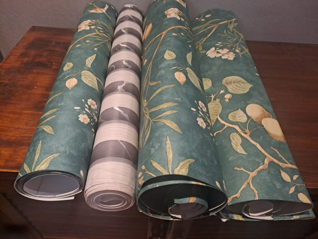 Lot of 3 Wallpaper Rolls — Two Green Floral (partial) + One Grey/White Striped (appears complete)