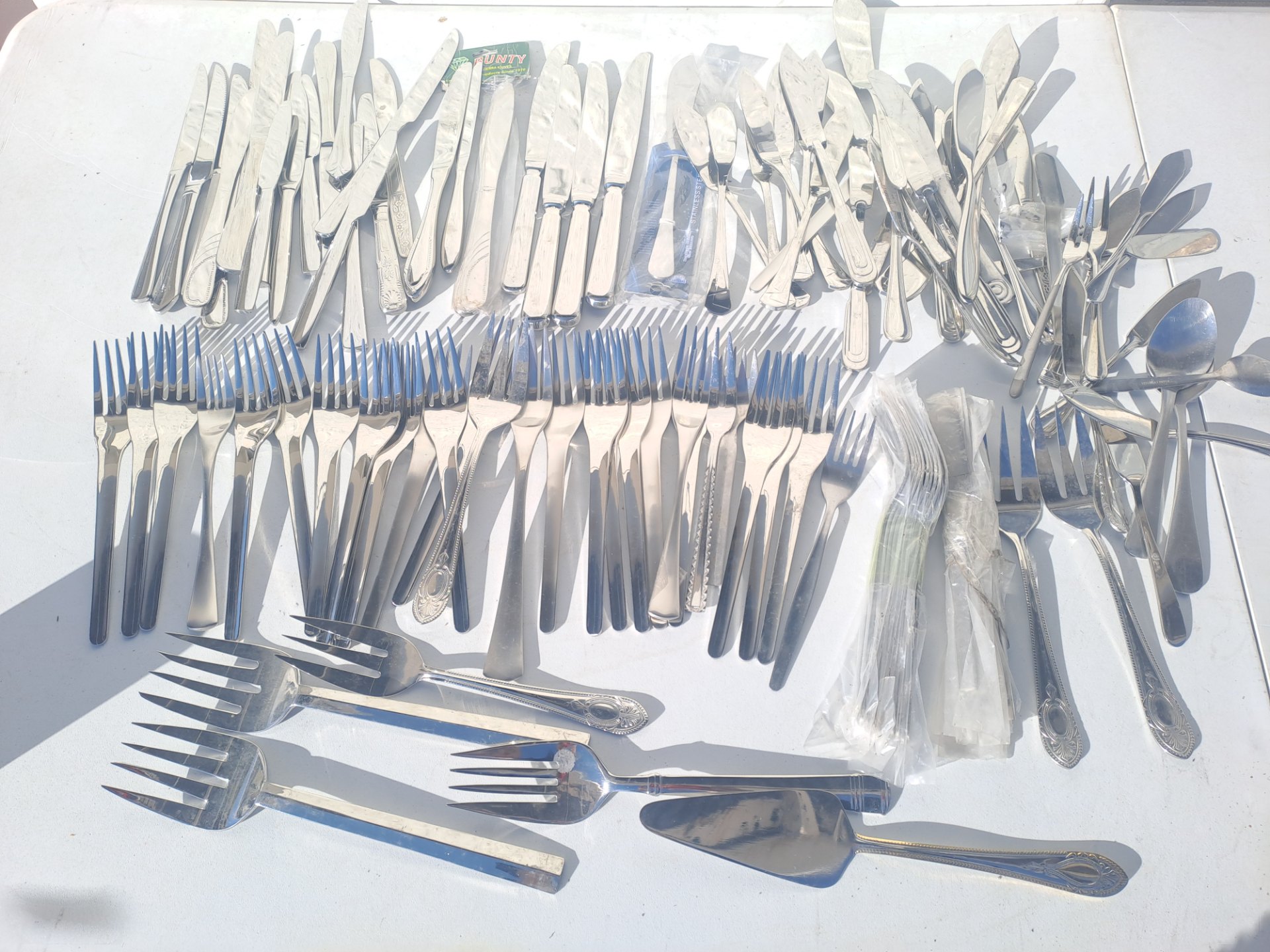 Mixed Stainless Steel Cutlery Lot — Assorted Forks, Knives, Spoons & Serving Pieces (Mixed Patterns, mostly unused)