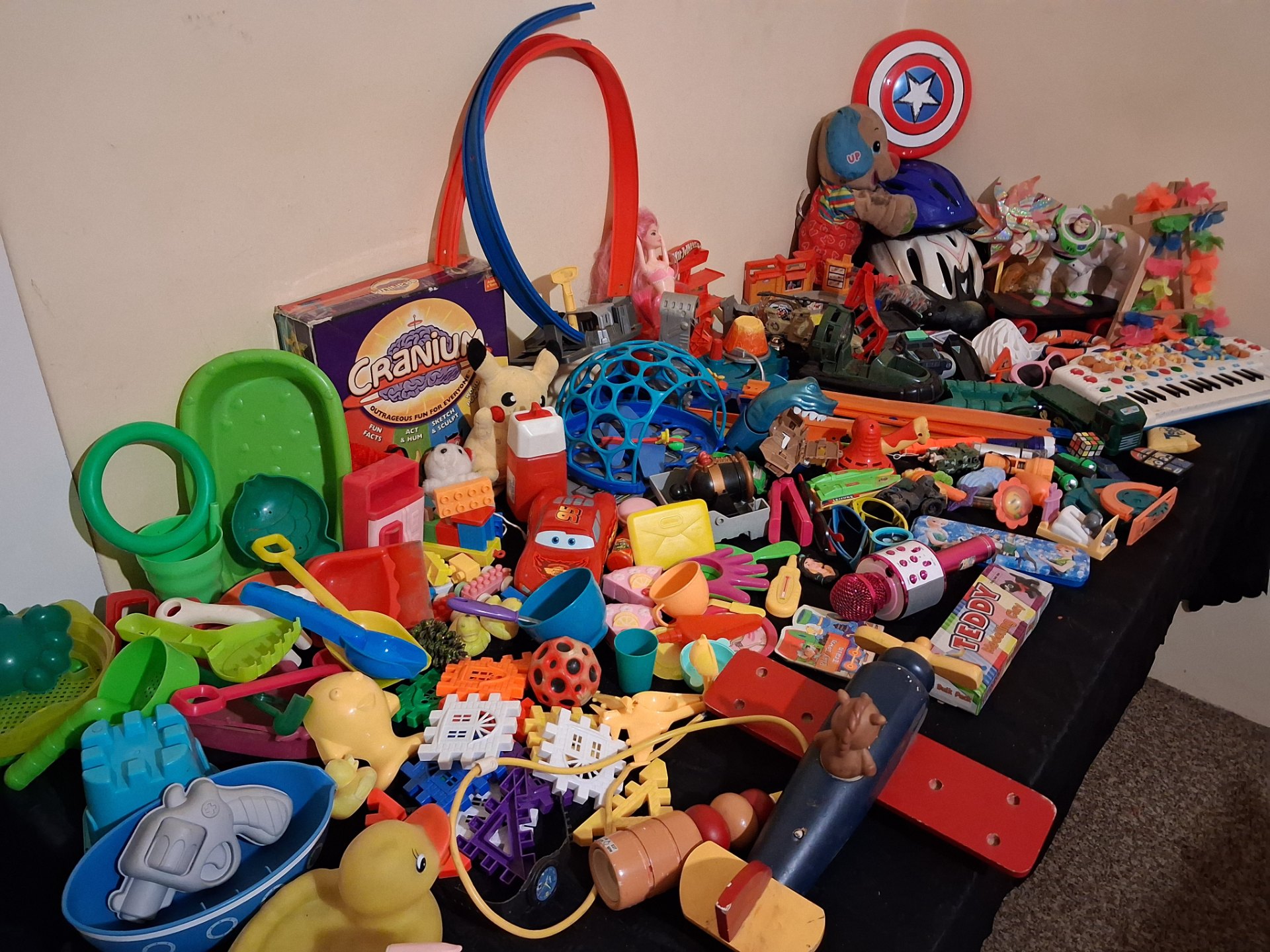 Bulk mixed children’s toys lot — 70+ assorted pieces (Hot Wheels track, Cranium box, plush, electronic keyboard) — used, untested electronics