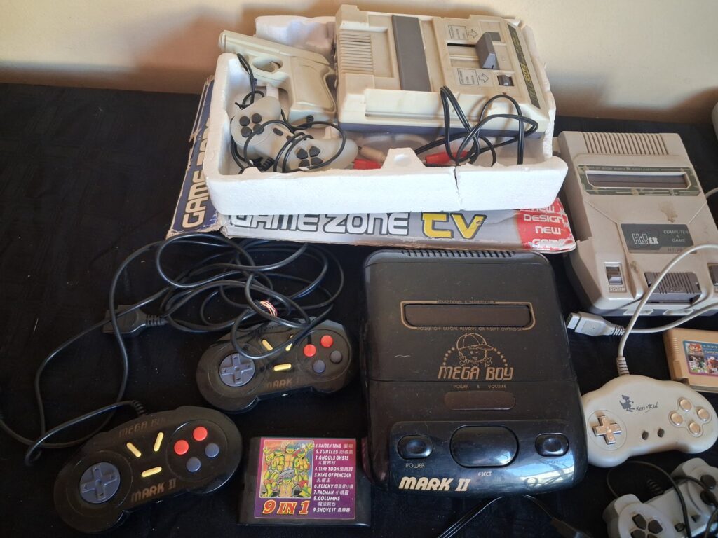 Mixed lot of ~25 famiclone-style consoles, controllers, light guns, AV leads & cartridges — untested, sold as-is