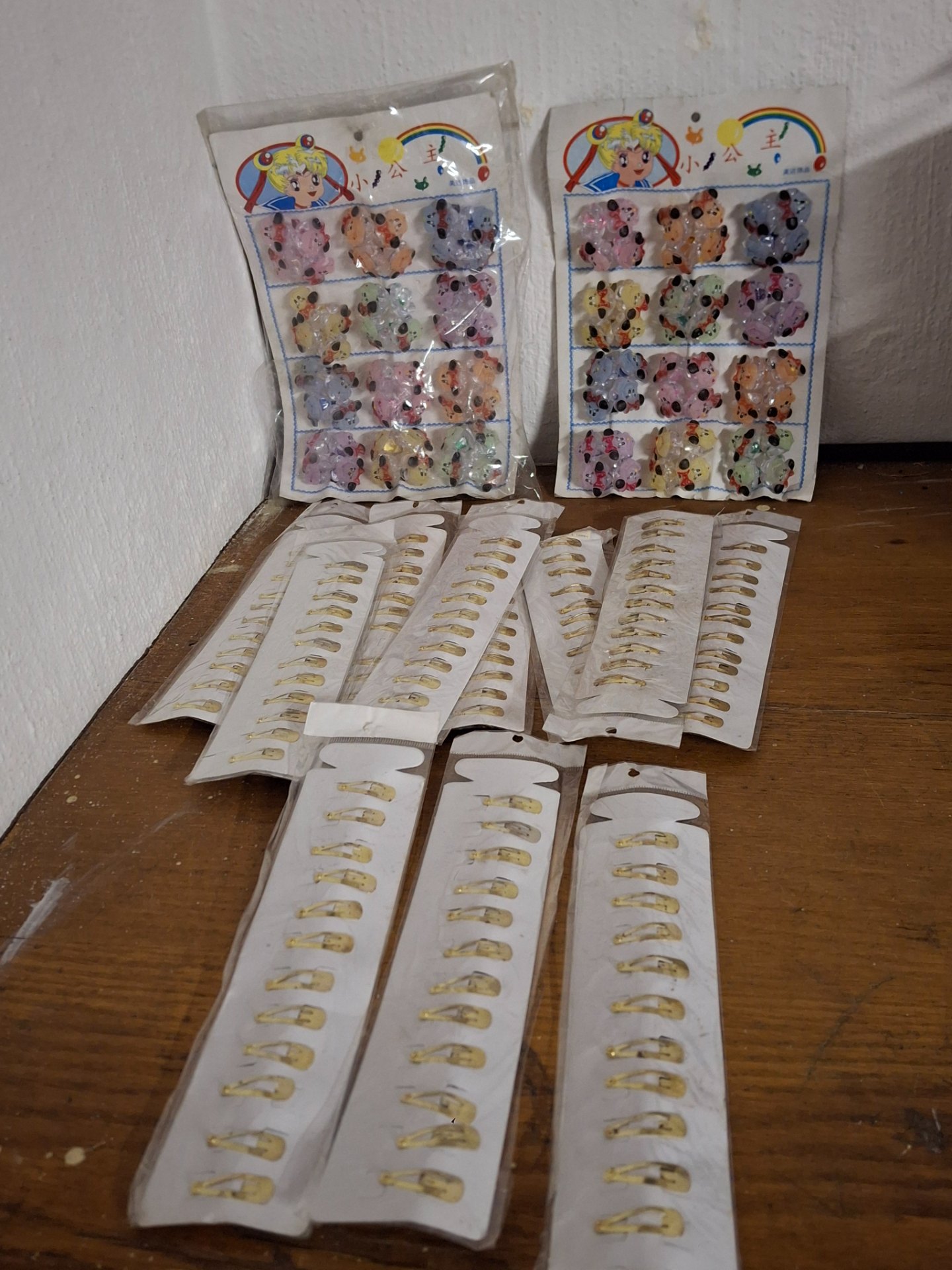 Mixed lot of children’s hair clips — gold-tone snap clips + sealed cartoon character plastic clips (original cards, aged packaging)