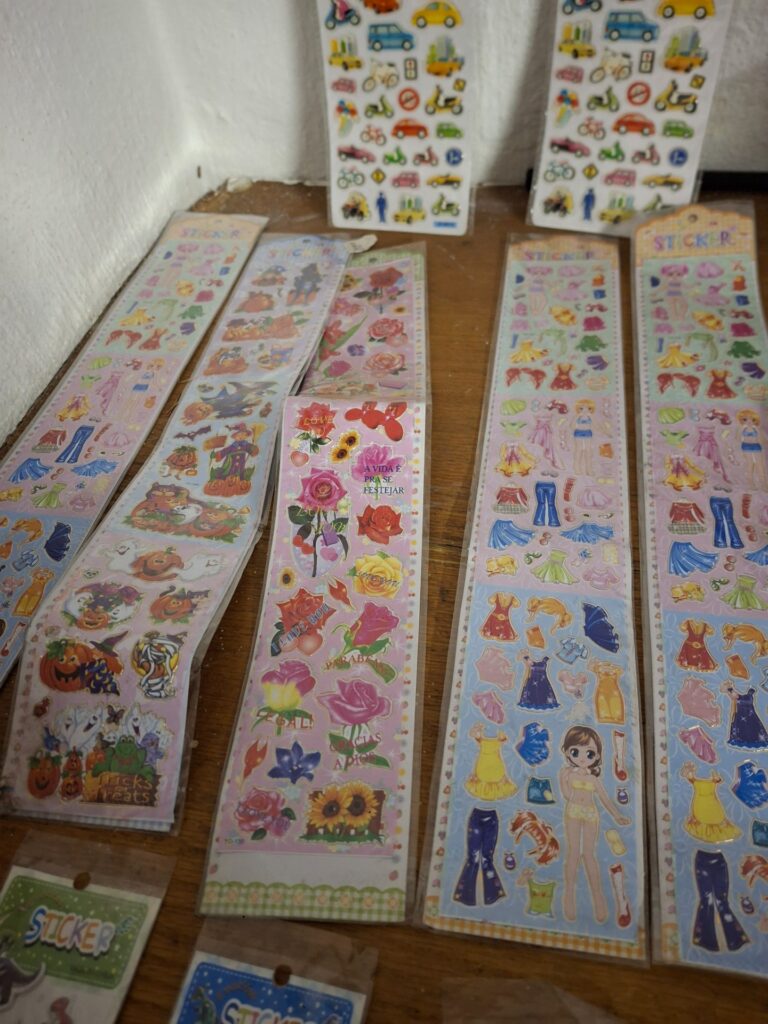 Mixed children’s sticker sheets — dress-up, dinosaurs, vehicles (assorted, mostly sealed)