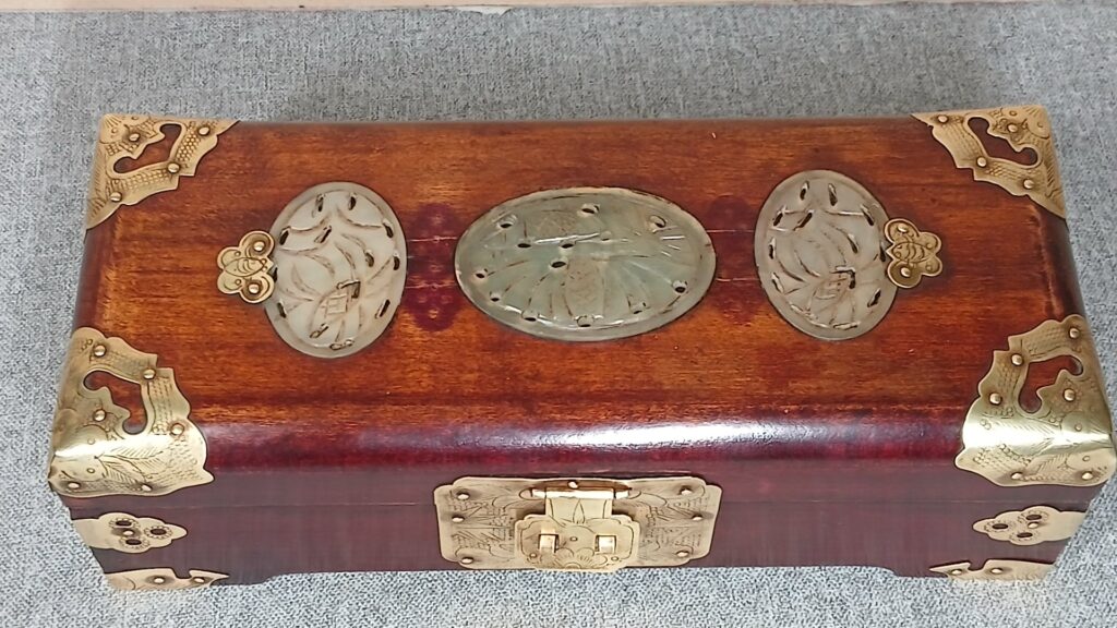 Chinese wooden jewellery box with carved green oval inlays and brass mountings