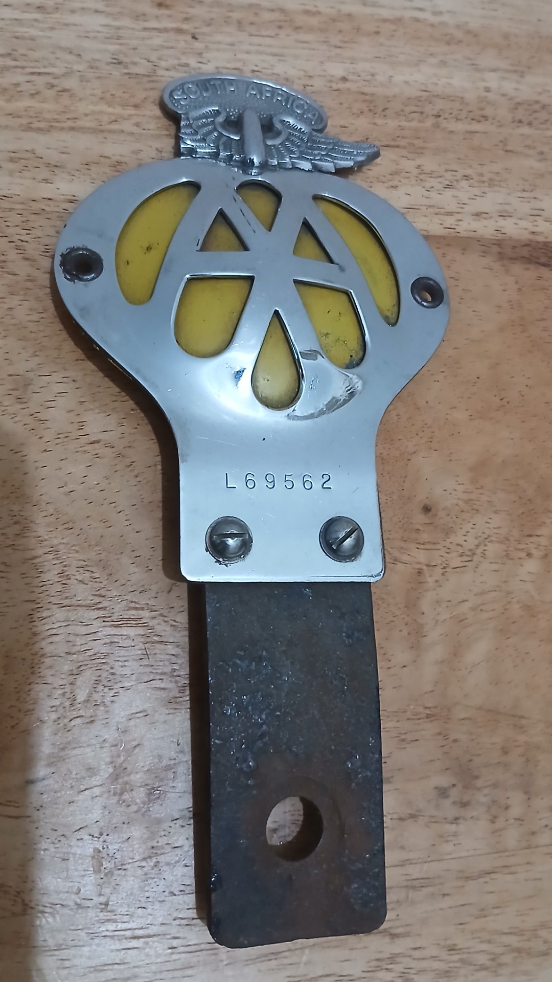AA (Automobile Association) South Africa car badge on steel mounting bracket — stamped L69562
