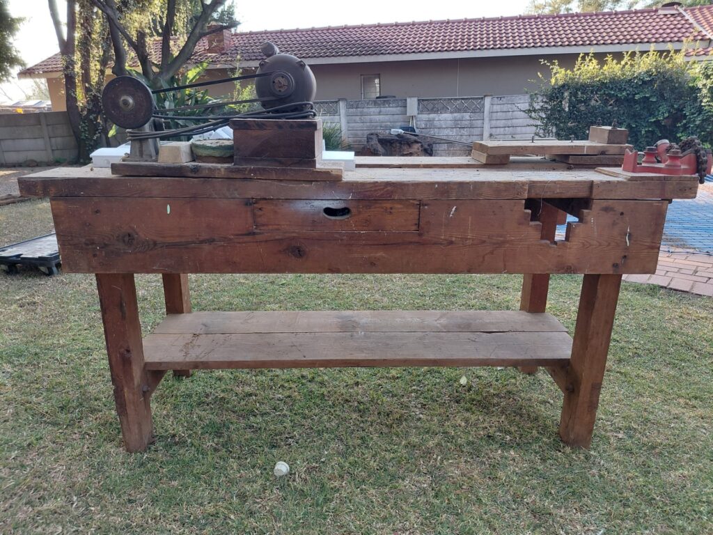 Heavy wooden joiner’s workbench with drawer, lower shelf + pipe bender & old bench grinder (rusted but reported working)
