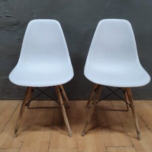 Pair of white plastic shell chairs with wooden legs — used, needs clean