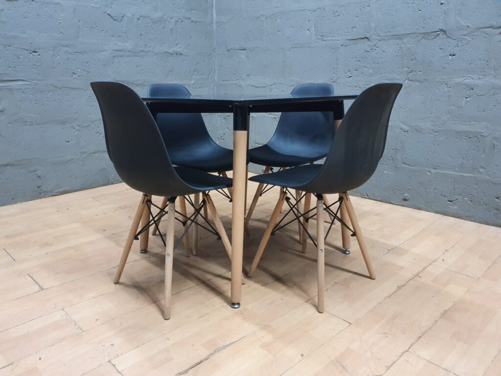 5‑piece dining set — square black table + 4 black plastic‑shell chairs (80x80x75 cm)