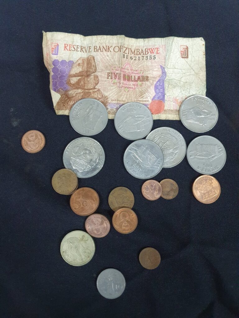 Mixed world coin lot + Zimbabwe Reserve Bank Five Dollars note (Harare 1997) — circulated, est. 14–20 pcs