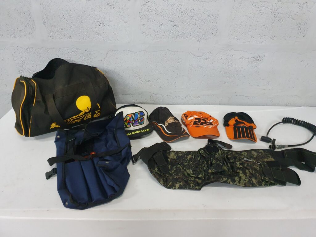 Assorted caps, bags, camo Spyder vest & coiled cable — mixed used lot (6 items)