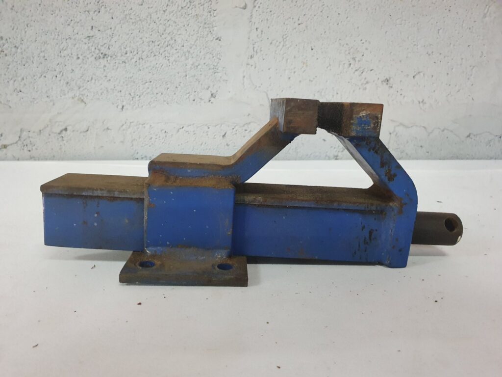 Small Blue Bench Vise Body — metal workshop vise (missing lead screw/handle, rusty, jaws 11 cm open)