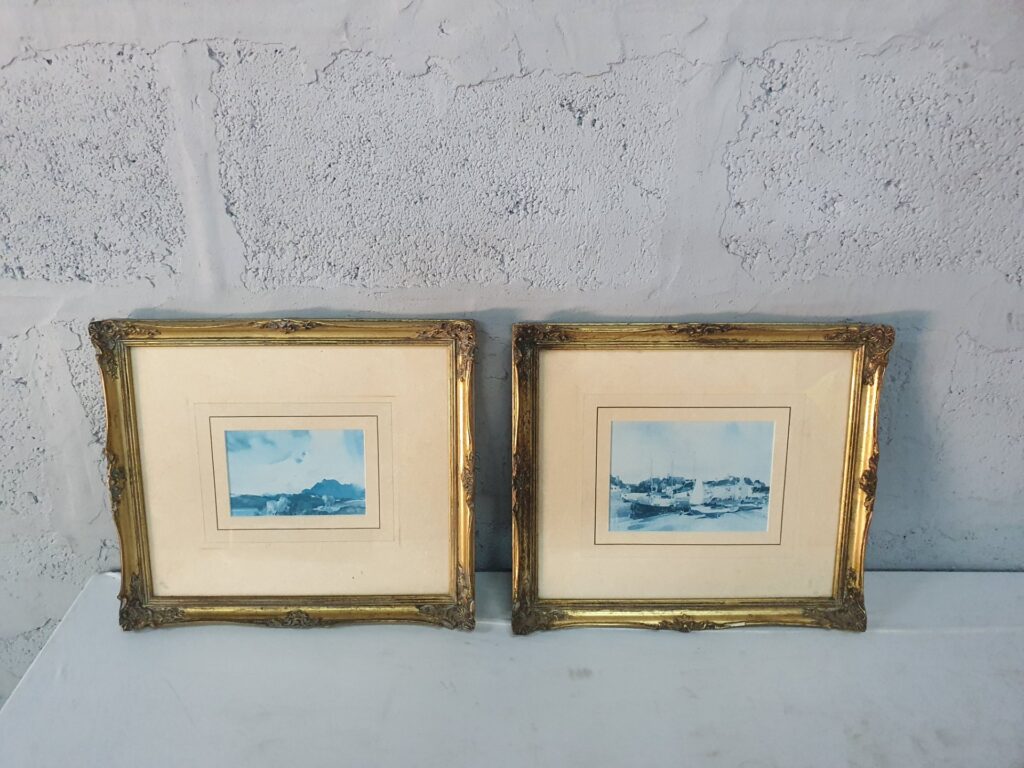 Pair of gilt decorative frames with blue-toned landscape prints — sold together (38 x 34 x 4 cm each)