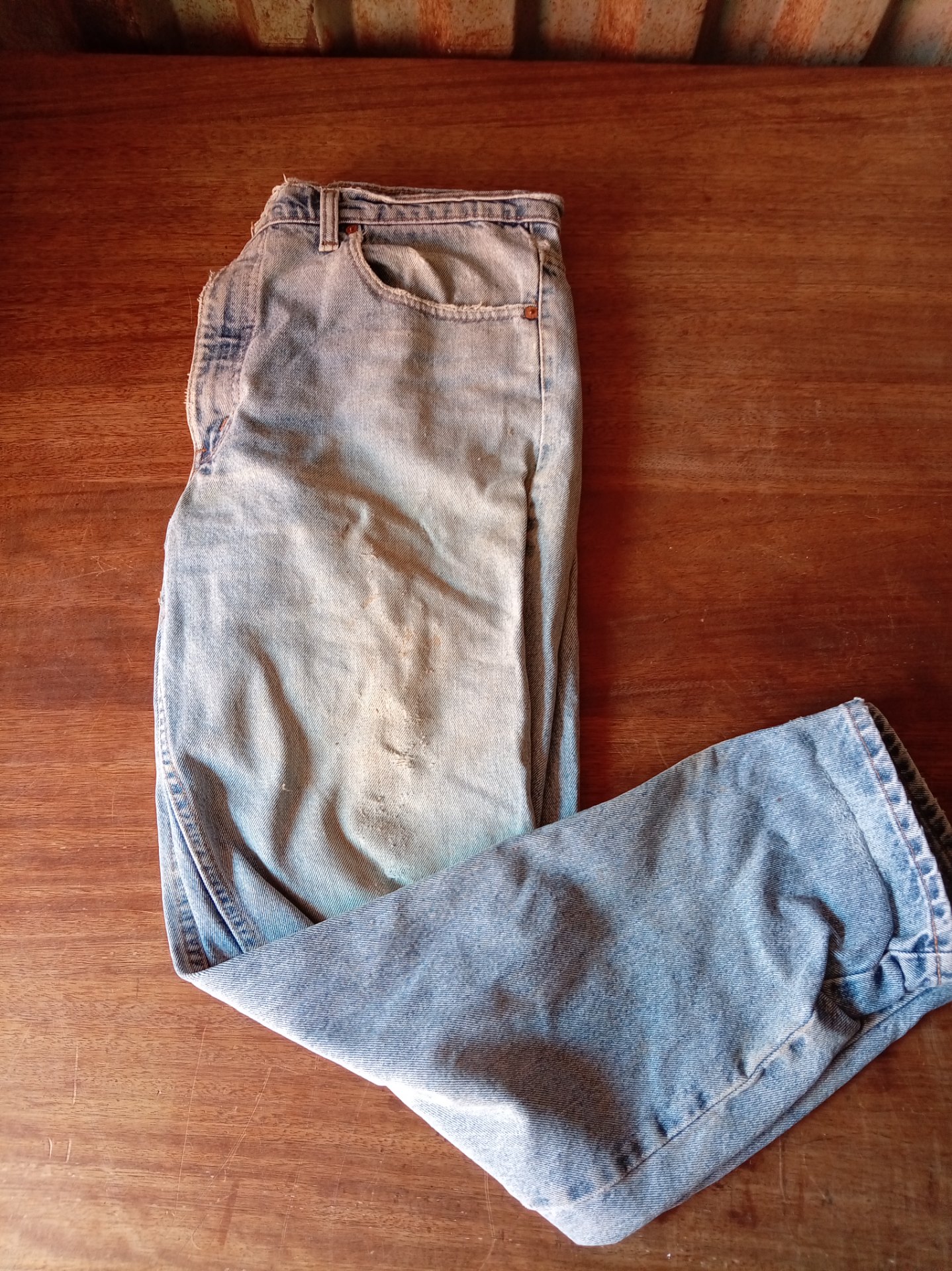 Vintage Levi’s 550 light‑wash jeans — Size 38 x 32 (Heavily worn, ripped)
