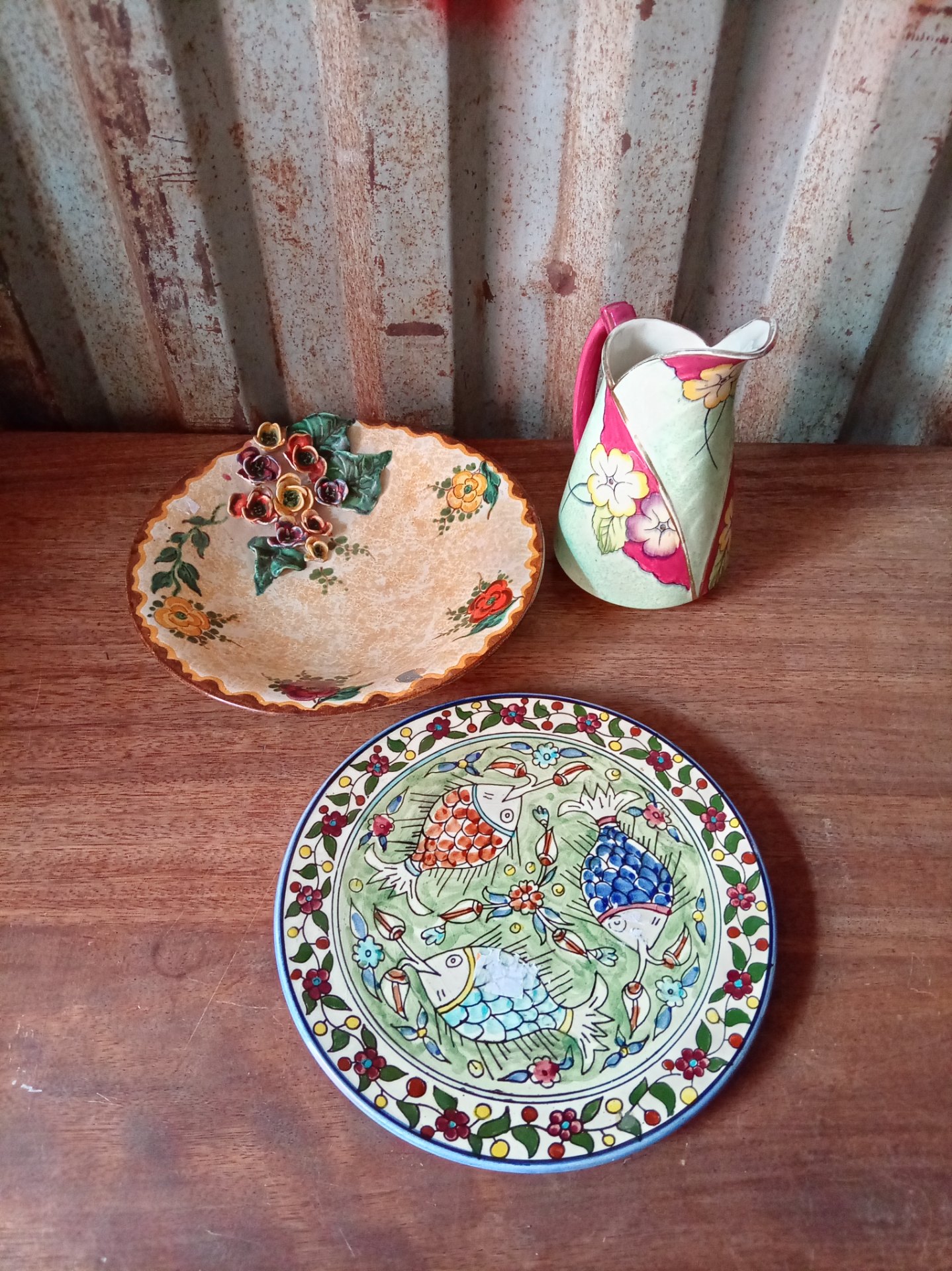 Mixed decorative ceramics lot – hand‑painted fish plate, applied‑flower plate and floral jug (3 pieces)