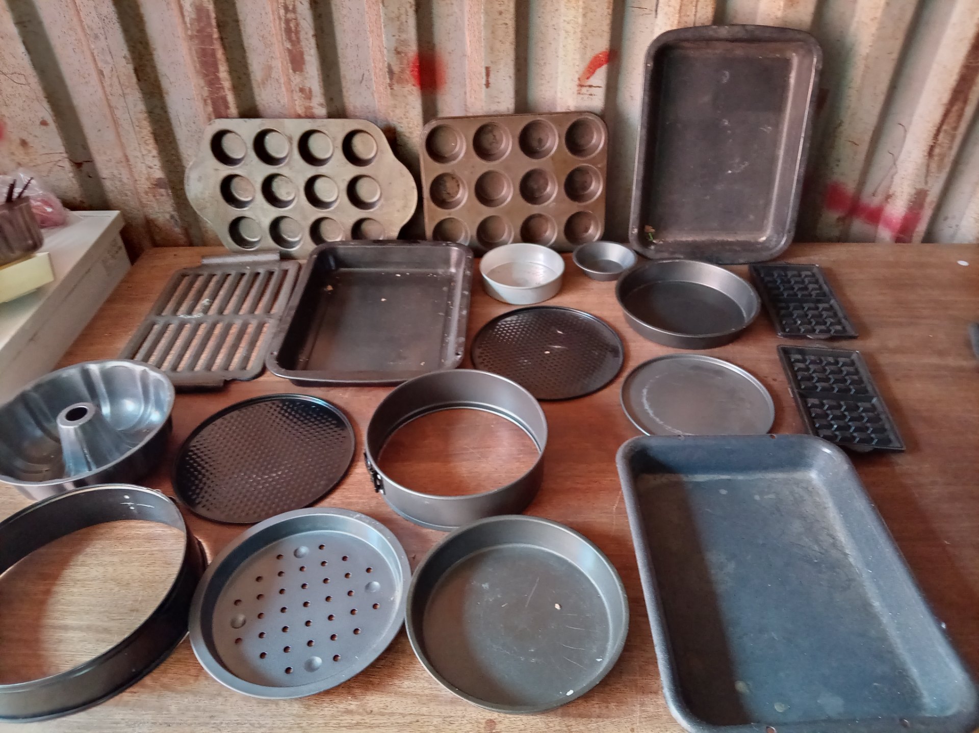 Bulk lot of mixed baking tins & trays — muffin pans, cake rings, bundt & baking sheets (used)