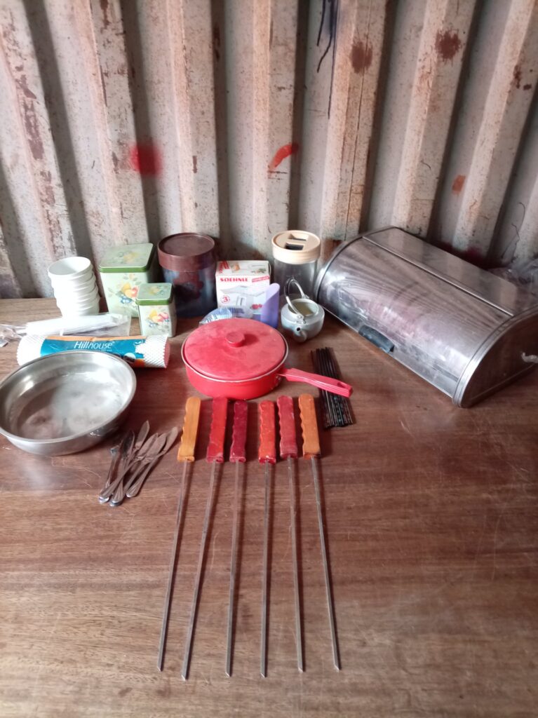 Mixed lot of used kitchen utensils — 6 long skewers, bread bin, red lidded pan, boxed Soehnle scale & assorted tins/cutlery