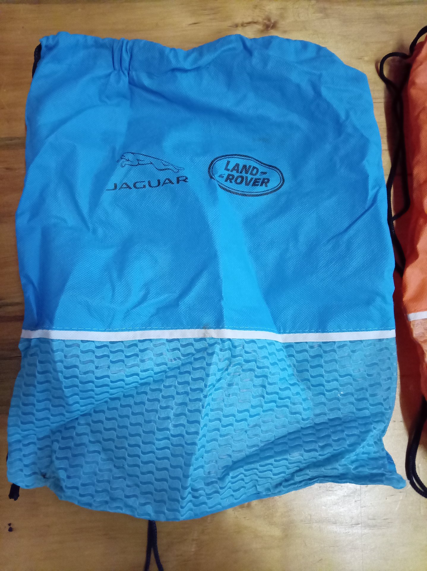 Pair of Jaguar & Land Rover printed drawstring bags — blue + orange, used