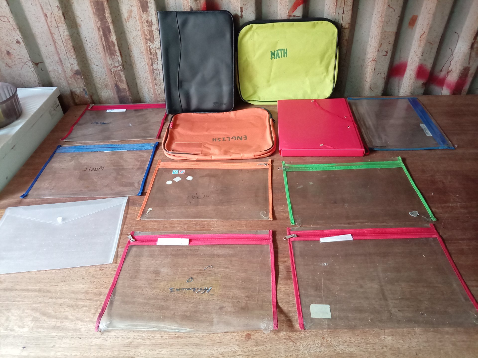 Mixed lot of clear PVC document sleeves, zip pouches & soft school folders — used, visible wear