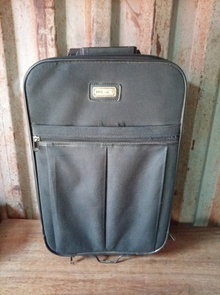 Used black soft‑shell wheeled suitcase – wheels & telescopic handle functional, frayed base