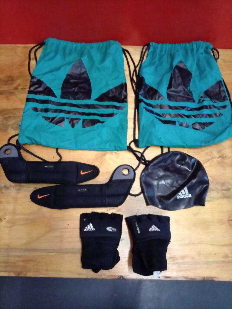 Mixed sports accessories lot — 2 x Adidas drawstring bags, Adidas swim cap, Adidas gloves & 2 x Nike padded ankle weights/straps