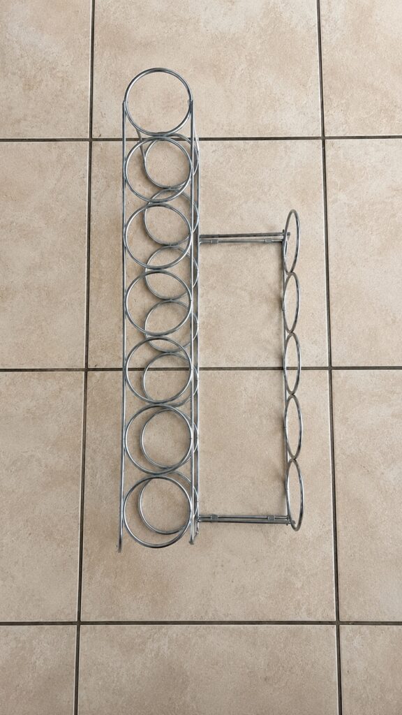 Chrome metal wine bottle rack — two-section design, circular bottle holders, used with light surface wear
