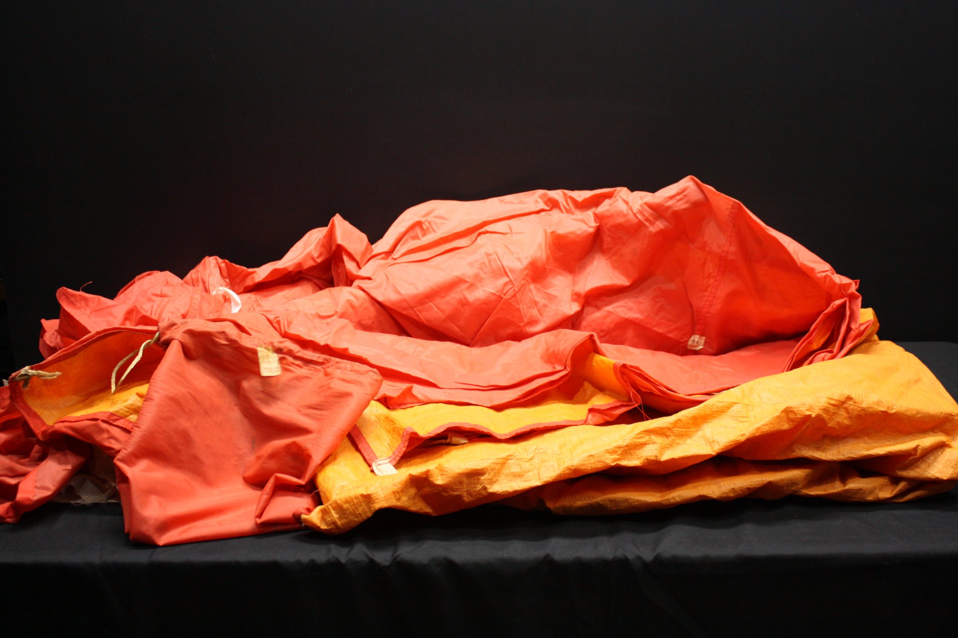Orange nylon ‘Two‑Man’ tent body in stuff sack — tag reads 100% NYLON, Made in Taiwan (NO POLES)