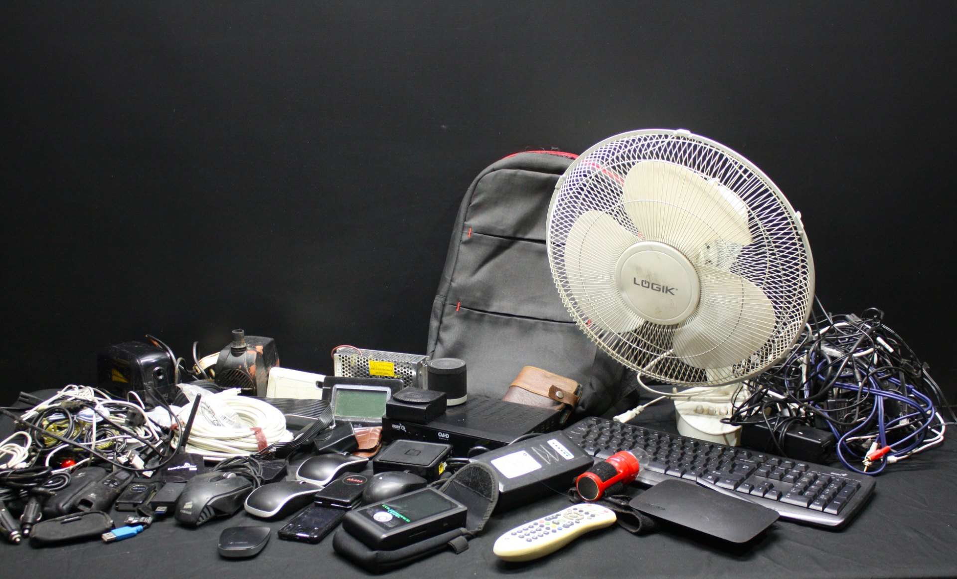 Mixed lot of used small electronics, accessories & Logik desk fan — untested, sold as-is