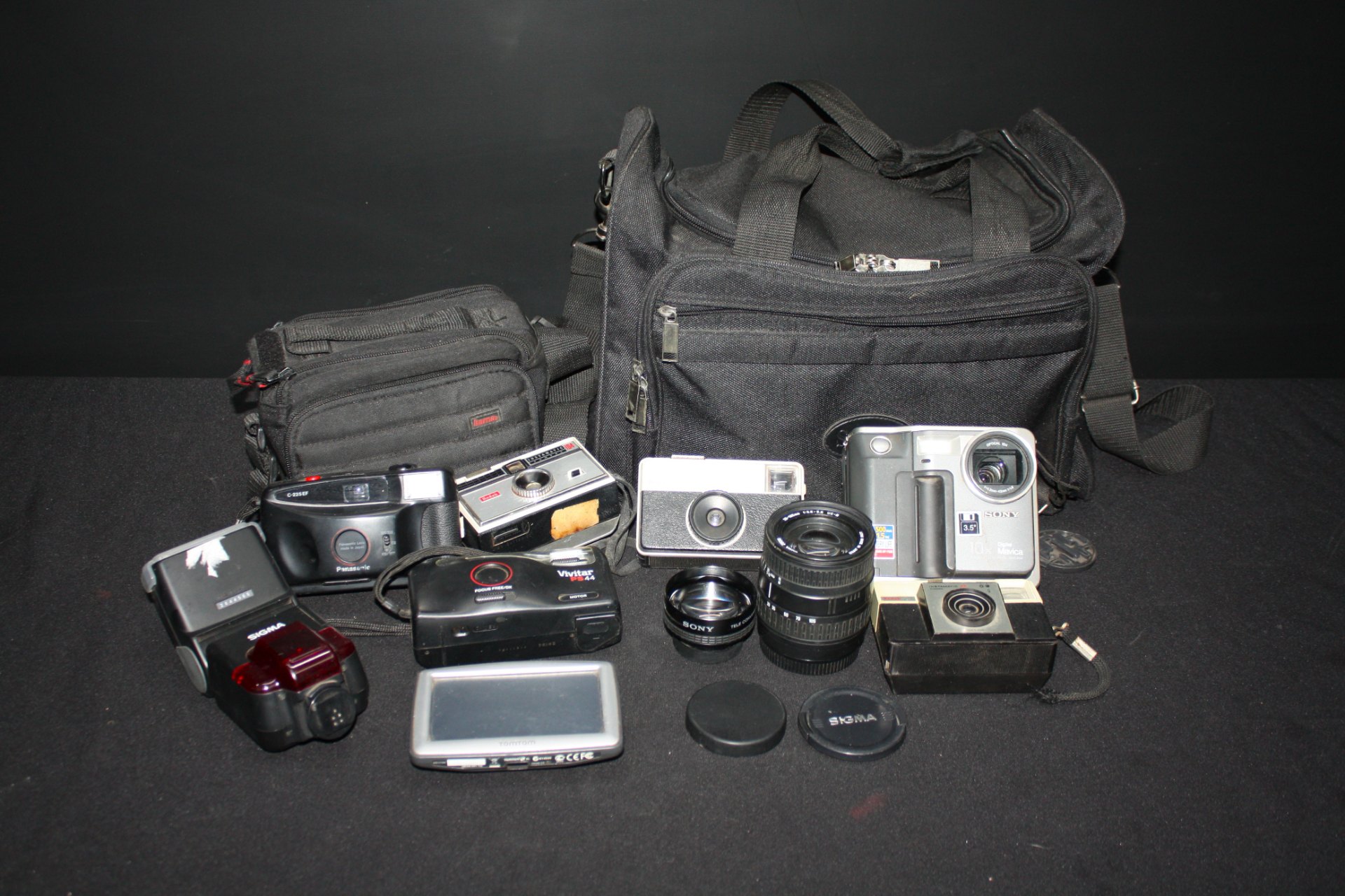 Mixed lot of cameras, lenses, flashes, TomTom GPS & bags — Sony Mavica MVC-FD7 pictured