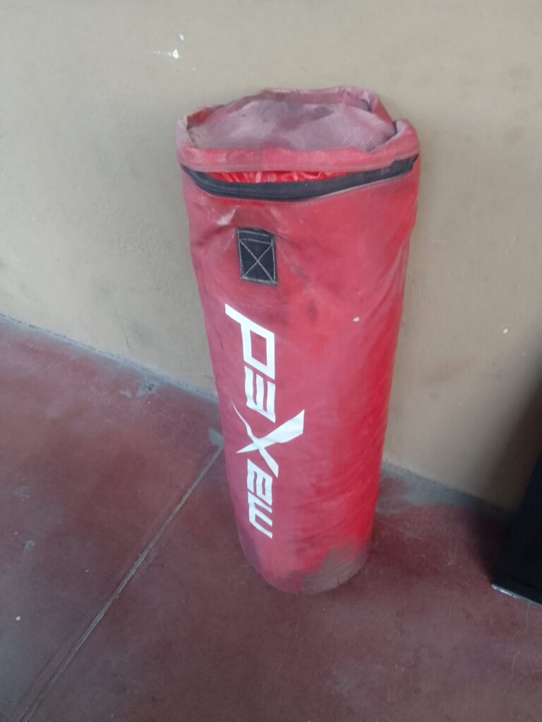 Red Fabric Filled Punching Bag – approx. 1m x 40cm, stitched hanging patch, needs straps & a clean