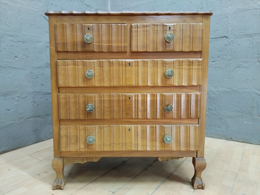 Tall wooden chest of drawers — scalloped top edge, carved claw feet, fitted liners
