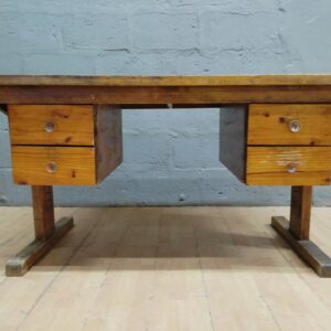 Solid wooden desk / work table with twin drawer banks, heavy surface wear