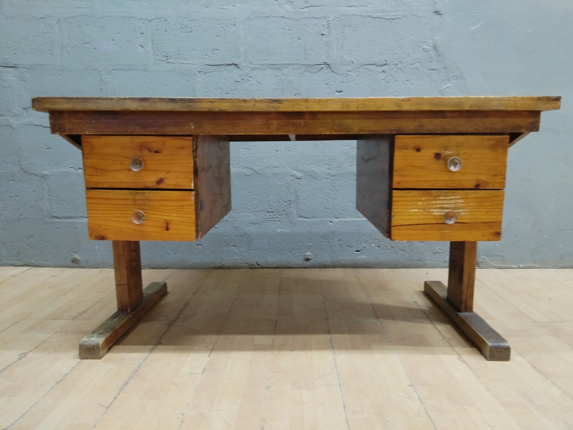 Solid wooden desk / work table with twin drawer banks, heavy surface wear