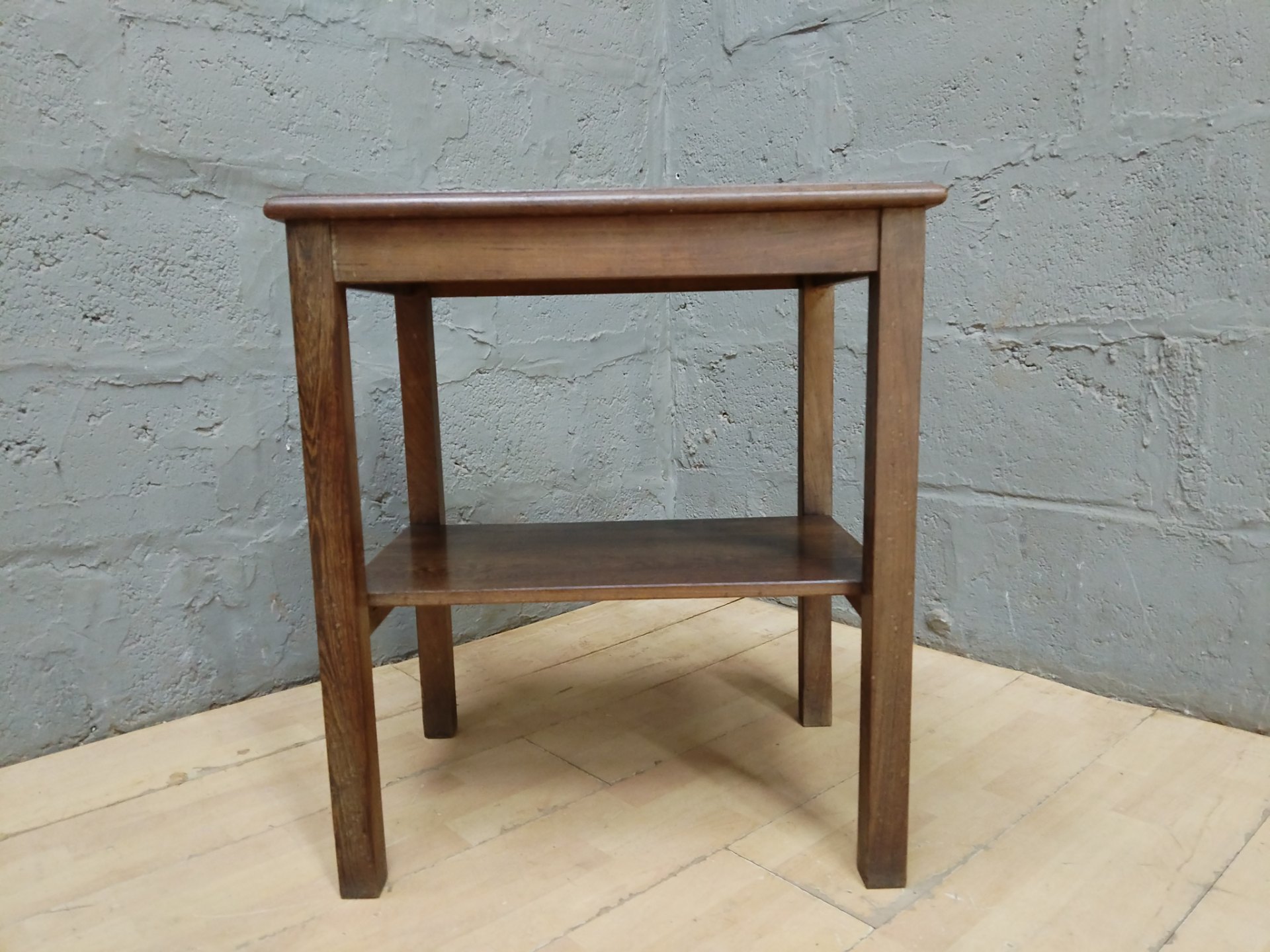 Small oak two-tier side table — solid structure, two shelves, surface wear