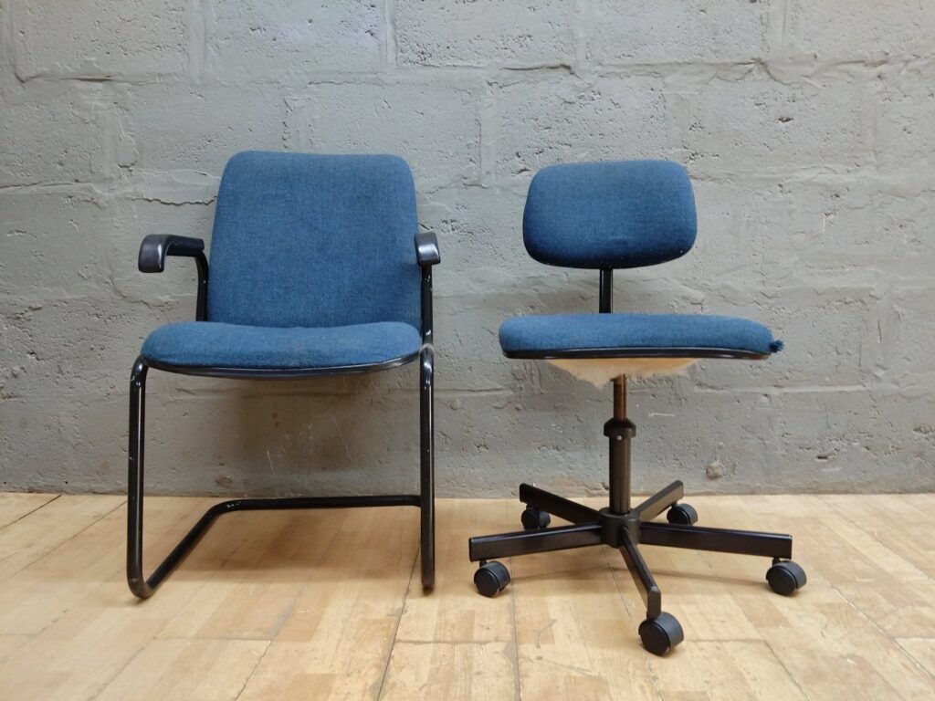 Pair of blue office chairs — cantilever visitor chair + height-adjustable swivel on castors
