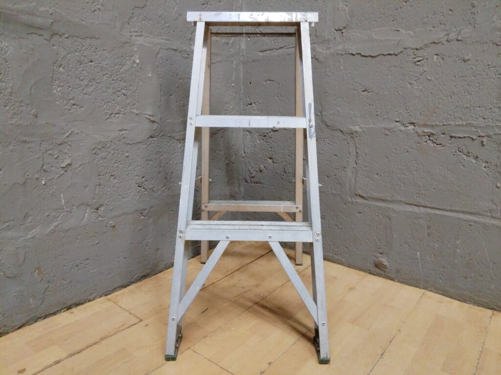 Aluminium folding A‑frame step ladder — top platform 85 cm, workshop-used with paint splatters