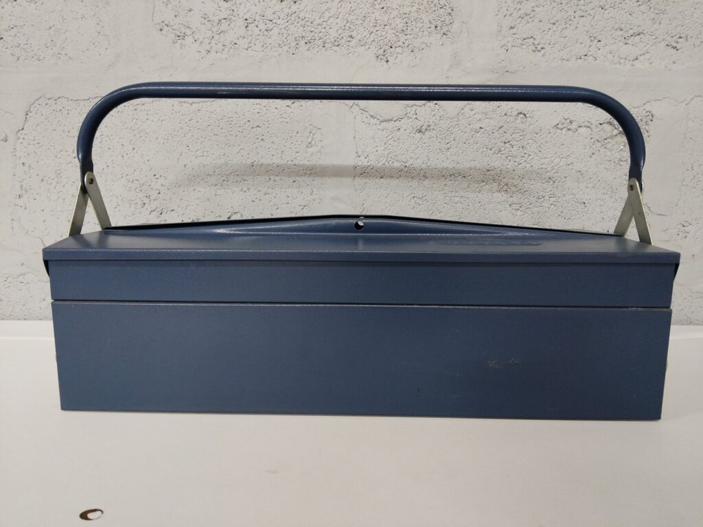 Blue metal cantilever toolbox – portable with locking latch, dented lid & surface wear