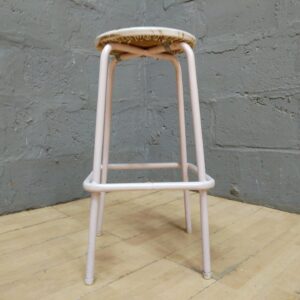 Pale-pink tubular metal bar/bench stool with padded vinyl seat — used, cracked vinyl & frame paint wear