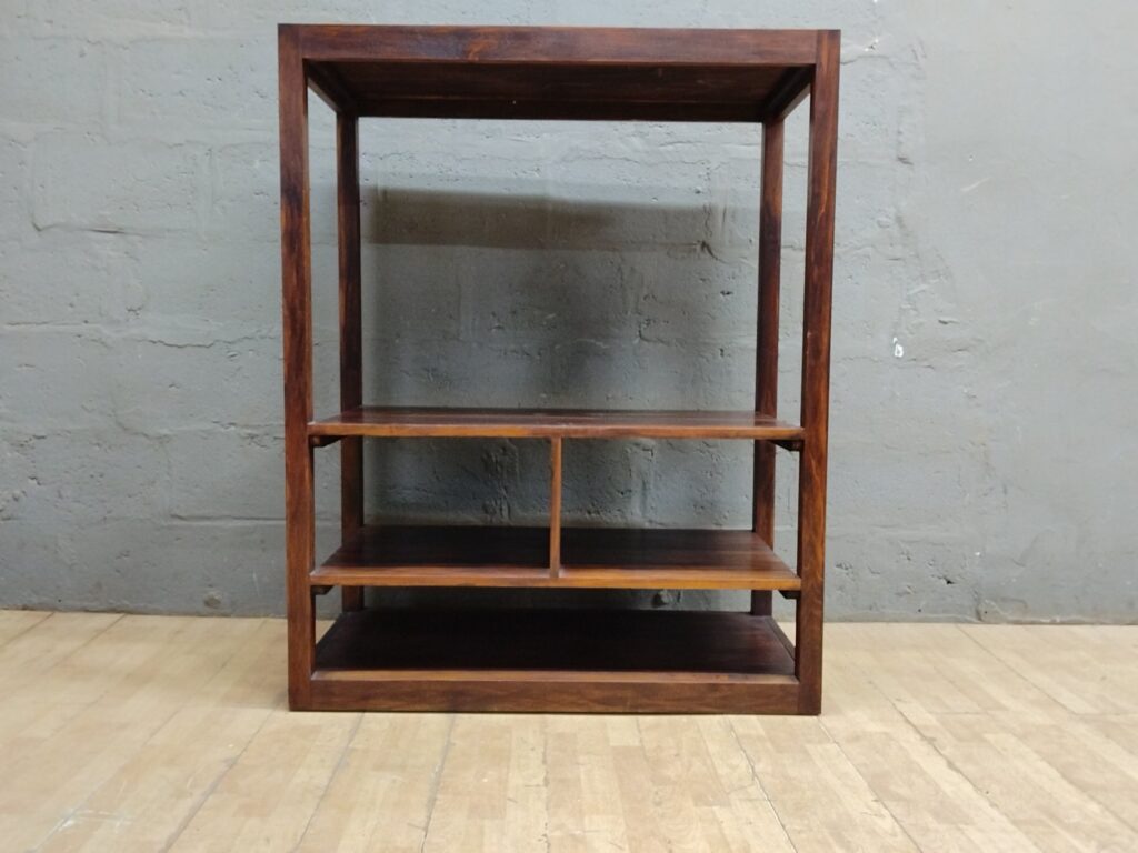 Open wooden shelving unit / bookcase — multi-shelf, fixed shelves, visible surface wear
