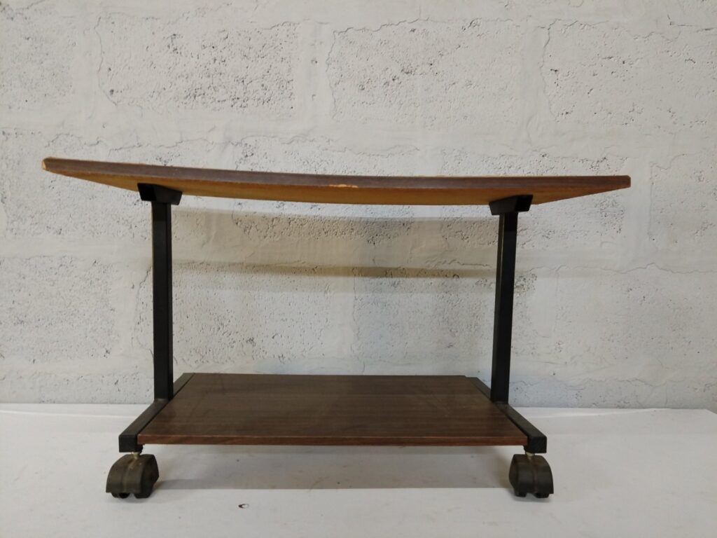Two-tier wood-look trolley on castors — black metal frame, used with edge chips