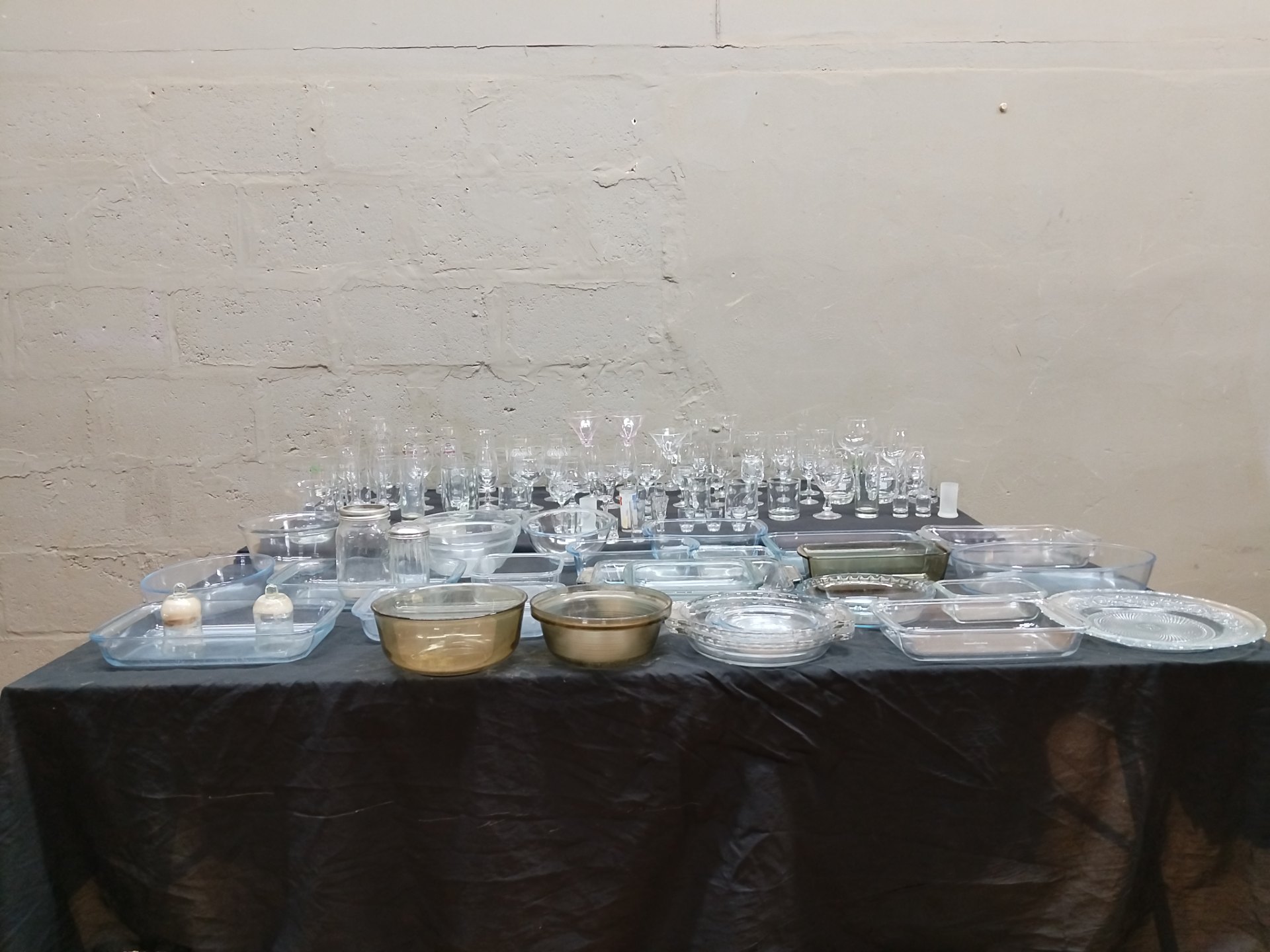 Bulk mixed glassware & bakeware lot – approx. 70 pieces (glasses, bowls, trays, branded pint glasses)