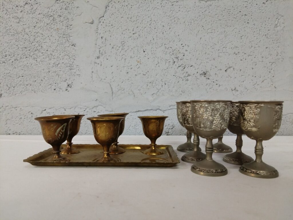 Mixed lot of small metal goblets & tray — 6 gold‑tone cups on tray + 6 ornate silver‑coloured stem goblets